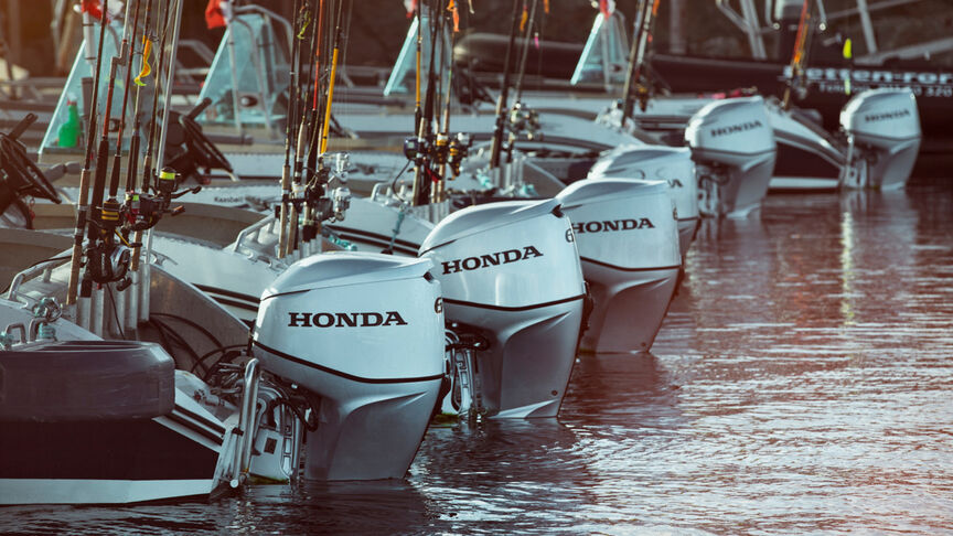 Ett utbud av Honda BF60-motorer på baksidan av båtar på vattnet. 